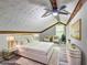 Staged attic bedroom with wood beams, hard wood floors, and decor at 2685 Peachtree Walk Walk, Duluth, GA 30096