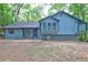 The back of the house shows a patio and siding on this two-story home surrounded by green foliage at 2685 Peachtree Walk Walk, Duluth, GA 30096