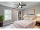 Staged bedroom highlighting a bed, closet, and scenic window view at 2685 Peachtree Walk Walk, Duluth, GA 30096