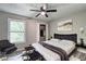 Modern bedroom featuring a comfortable bed, stylish furniture, and a ceiling fan for added comfort at 2685 Peachtree Walk Walk, Duluth, GA 30096