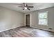 Neutral bedroom with wood floors, ceiling fan, closet, and natural light at 2685 Peachtree Walk Walk, Duluth, GA 30096