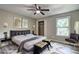 Elegant bedroom with a luxurious bed, stylish decor, and a cozy seating area at 2685 Peachtree Walk Walk, Duluth, GA 30096