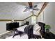 Cozy bedroom features ceiling fan, stylish decor, and natural light from the window at 2685 Peachtree Walk Walk, Duluth, GA 30096