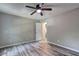Minimalist bedroom with sleek flooring, neutral walls, and an open doorway leading to another room at 2685 Peachtree Walk Walk, Duluth, GA 30096