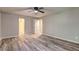 Spacious bedroom featuring stylish flooring, neutral walls, and ample natural light from the doorway at 2685 Peachtree Walk Walk, Duluth, GA 30096