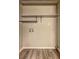 Empty room featuring wire rack shelving, utility connections, and wood-look flooring at 2685 Peachtree Walk Walk, Duluth, GA 30096