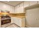 Well-lit kitchen equipped with stainless steel appliances, light wood counters, and ample white cabinetry at 2685 Peachtree Walk Walk, Duluth, GA 30096