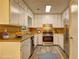 Well-lit kitchen equipped with stainless steel appliances, light wood counters, and ample white cabinetry at 2685 Peachtree Walk Walk, Duluth, GA 30096