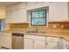 Bright kitchen featuring stainless steel dishwasher and double sink with a view at 2685 Peachtree Walk Walk, Duluth, GA 30096