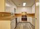 Well-lit kitchen equipped with stainless steel appliances, light wood counters, and ample white cabinetry at 2685 Peachtree Walk Walk, Duluth, GA 30096