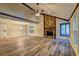 Bright living room featuring a stone fireplace, vaulted ceiling, ceiling fan, and wood-look flooring at 2685 Peachtree Walk Walk, Duluth, GA 30096