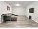 Finished basement with gray walls and floors offers a comfortable living space with a cozy sectional couch at 3152 Andora Sw Trl, Marietta, GA 30064