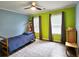 Bright bedroom features a ceiling fan and sunlit windows with gray curtains and hardwood flooring at 3152 Andora Sw Trl, Marietta, GA 30064