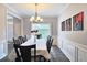 Elegant dining room featuring a chandelier, wainscoting, and a dining set, creating an inviting space at 3152 Andora Sw Trl, Marietta, GA 30064