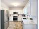 Bright kitchen featuring stainless steel appliances, white cabinets, granite countertops, and tile backsplash at 3152 Andora Sw Trl, Marietta, GA 30064