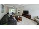 Open-concept living room with a fireplace, large windows, and hardwood floors, blending comfort and style at 3152 Andora Sw Trl, Marietta, GA 30064