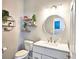 Stylish powder room with floating shelves, decor, and modern fixtures at 3152 Andora Sw Trl, Marietta, GA 30064