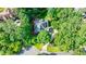 Stunning aerial view of a well-maintained home surrounded by lush greenery and mature trees at 525 Avala Ct, Johns Creek, GA 30022