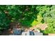 Scenic aerial view of a home featuring a spacious deck and green backyard with mature trees at 525 Avala Ct, Johns Creek, GA 30022