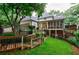 Home exterior featuring multi-level deck and landscaped backyard with fence at 525 Avala Ct, Johns Creek, GA 30022