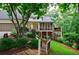 Landscaped backyard with multi-level deck, patio, and fenced-in yard at 525 Avala Ct, Johns Creek, GA 30022