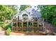 Exterior featuring multi-level decks and large backyard with mature trees at 525 Avala Ct, Johns Creek, GA 30022