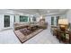 Finished basement with a large sectional sofa and access to the backyard at 525 Avala Ct, Johns Creek, GA 30022