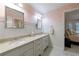 Well-lit bathroom with dual sinks, stylish fixtures and neutral toned walls at 525 Avala Ct, Johns Creek, GA 30022