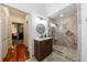 Modern bathroom with stone shower, updated vanity, and unique tile flooring at 525 Avala Ct, Johns Creek, GA 30022