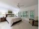 Bright bedroom featuring large windows, plantation shutters, and a comfortable bed at 525 Avala Ct, Johns Creek, GA 30022