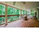 Spacious covered deck with outdoor seating area and wooded backyard at 525 Avala Ct, Johns Creek, GA 30022