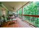 Spacious deck overlooking wooded area with outdoor seating and stone cooking area at 525 Avala Ct, Johns Creek, GA 30022