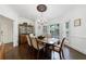 Formal dining room with hardwood floors, a chandelier, and white shutters on the windows at 525 Avala Ct, Johns Creek, GA 30022