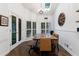 Light-filled dining room featuring a wooden table, bench, and view to the outside at 525 Avala Ct, Johns Creek, GA 30022