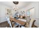 Elegant dining room with hardwood floors, chandelier, and views into the entryway and kitchen at 525 Avala Ct, Johns Creek, GA 30022