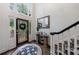 Bright foyer with stained-glass door, dark hardwood floors, and staircase with black banister at 525 Avala Ct, Johns Creek, GA 30022