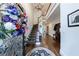 Elegant foyer with hardwood floors, staircase, chandelier and an ornate flower arrangement at 525 Avala Ct, Johns Creek, GA 30022