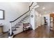 Hallway with hardwood floors, staircase, and bench seating looking down the hallway at 525 Avala Ct, Johns Creek, GA 30022