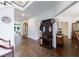 Spacious hallway featuring hardwood floors, antique decor, and access to multiple rooms at 525 Avala Ct, Johns Creek, GA 30022