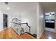 Upstairs hallway showcasing hardwood floors and a decorative light fixture at 525 Avala Ct, Johns Creek, GA 30022