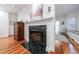 Hallway with hardwood floors and view of a black marble fireplace, with access to the bathroom and window seat at 525 Avala Ct, Johns Creek, GA 30022