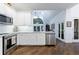 Bright kitchen featuring modern appliances, white cabinetry, and sleek granite countertops at 525 Avala Ct, Johns Creek, GA 30022