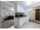 Convenient kitchen nook with white cabinets and granite counters, adjacent to an office space at 525 Avala Ct, Johns Creek, GA 30022