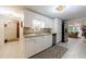 Inviting kitchen with white cabinetry and tile flooring, offering a seamless flow to the living area at 525 Avala Ct, Johns Creek, GA 30022