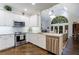Open-concept kitchen with a view to the living room and stainless steel appliances at 525 Avala Ct, Johns Creek, GA 30022