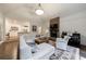 Spacious living room features a stone fireplace, white sectional, and piano for Gathering entertainment at 525 Avala Ct, Johns Creek, GA 30022