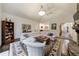 Open living room with a fireplace and large white sectional couch; kitchen visible in the background at 525 Avala Ct, Johns Creek, GA 30022