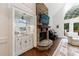 Inviting living room featuring a stone fireplace, piano, and well-appointed wet bar at 525 Avala Ct, Johns Creek, GA 30022