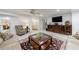 Spacious living room with tile flooring, ceiling fan, and a decorative rug providing warmth at 525 Avala Ct, Johns Creek, GA 30022
