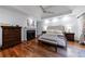 The bedroom features hardwood flooring, a fireplace, and a large bed with a tufted headboard at 525 Avala Ct, Johns Creek, GA 30022